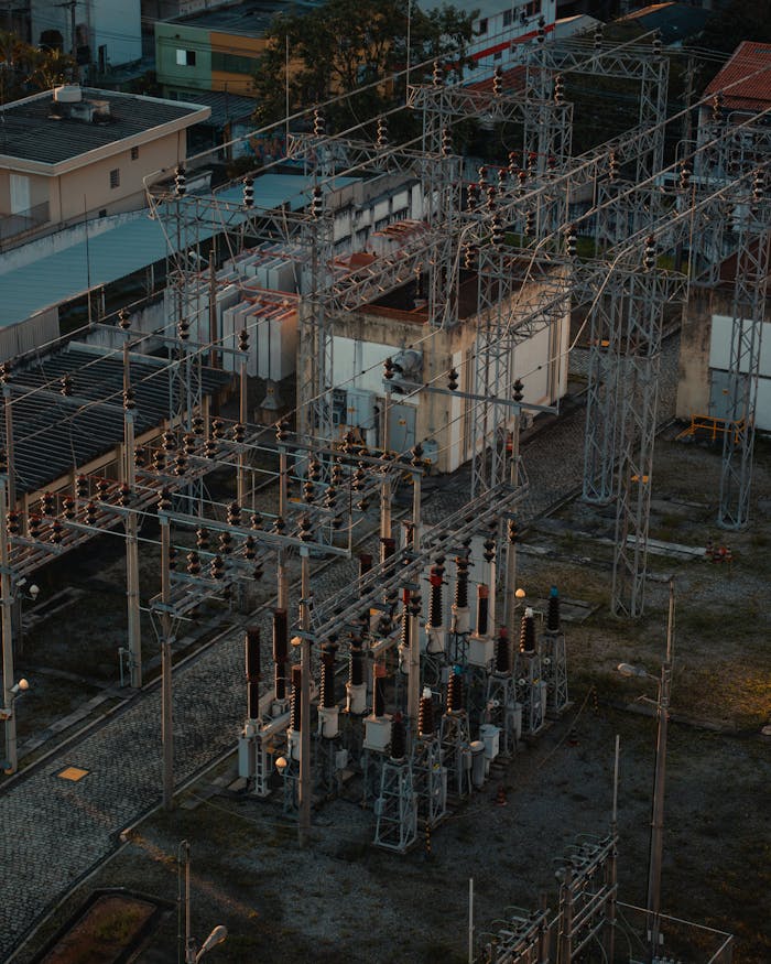 about-04 A detailed aerial view of a bustling electrical substation, showcasing industrial infrastructure.